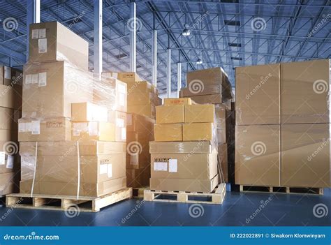 Stacked Of Package Boxes On Pallet Rack And Forklift Pallet Jack Waiting To Load Into Shipping