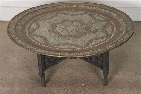 We elevated the 70's tv tray and called it a make a stylish statement in your living room with this coffee table. Moroccan Round Brass Tray Coffee Table at 1stdibs