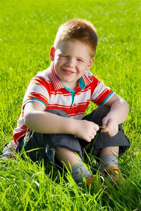 Boy Sitting On Field Of Grass Stock Image Image Of Play Beautiful