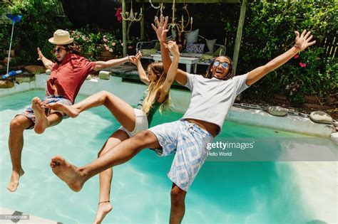 Three Fully Clothed Friends Falling Backwards Into Pool Photo Getty