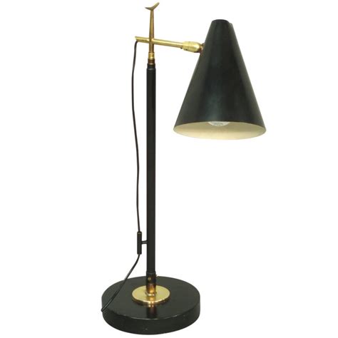 The lamp can direct light onto book or magazine easily and features elegant black cord. Swivel Base Telescoping Floor / Desk Lamp at 1stdibs