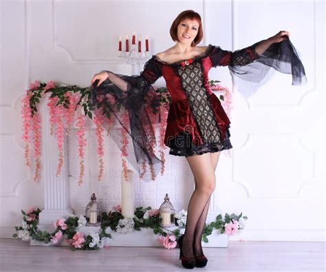 Redhead Legged Photomodel In Minidress And Black Stockings Posing In