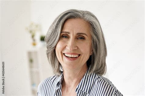 Cheerful Satisfied 50s Mature Woman Laughing Looking At Camera At Home Happy Sophisticated
