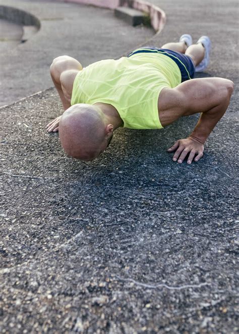 Muscular Man Doing Push Ups Outdoors Stock Photo