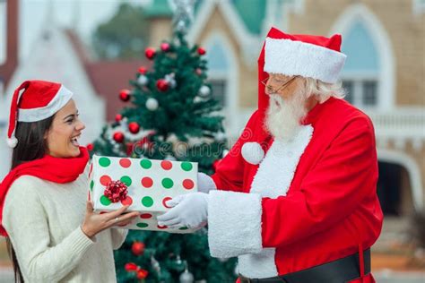 Santa Giving A T To A Young Woman Stock Photo Image 56319084