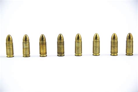 9mm Bullets Standing Next To Each Other On White Background Creative
