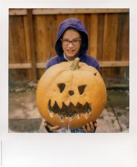 Eleven Year Old Girl Holds Large Jack O Lantern While Making A Scary