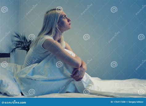 Sad Depressed Woman Sitting In Her Bed Late At Night She Is Pensive