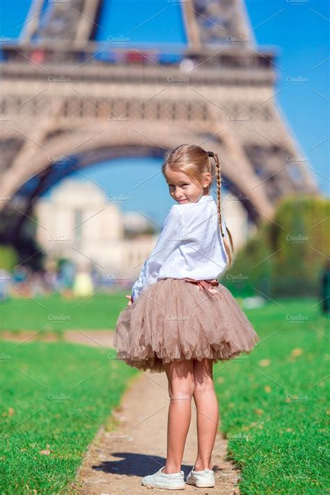 Adorable Little Girl Near The Eiffel Tower During Summer Vacation In