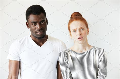 African Man Wearing White T Shirt Standing Next To His Caucasian