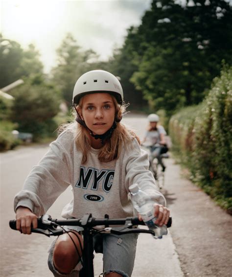 Download Teenage Blonde Girl Riding Bicycle Wallpaper