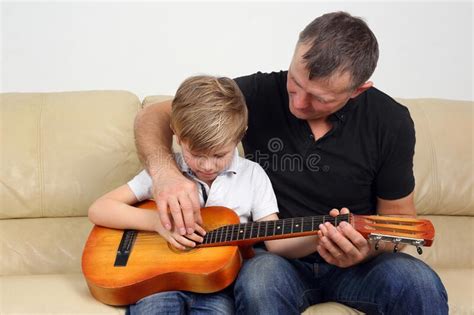 Father Teaches His Son To Play The Guitar Stock Image Image Of Lesson