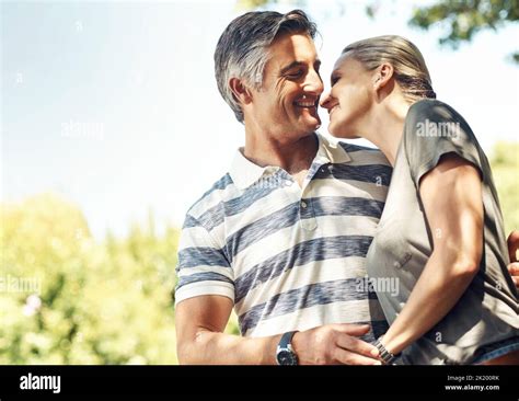 Sharing An Intimate Moment An Affectionate Mature Couple Enjoying A Day In The Park Stock Photo