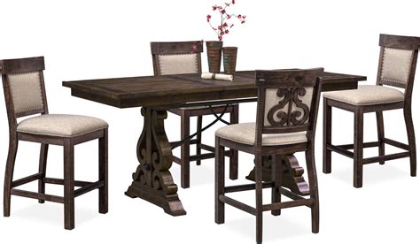 They are differentiated from more traditional dining room sets mainly because both the table and the chairs are taller. Charthouse Counter-Height Dining Table and 4 Upholstered ...