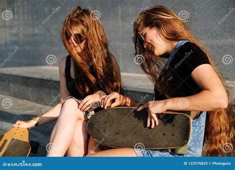 Young Beautiful Redhead Girls With Longboard And Skateboard Posing