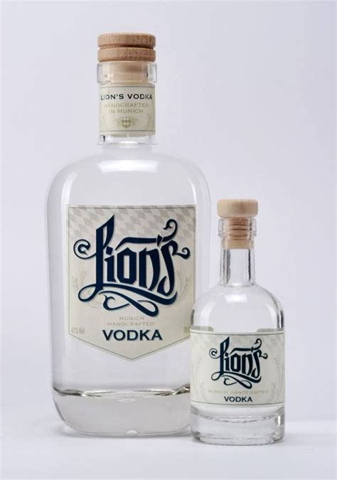 Two Bottles Of Korns Vodka Next To Each Other On A White Surface