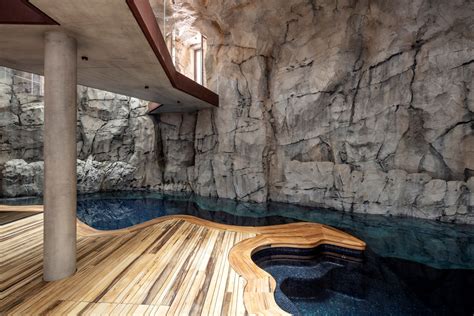 modern cave villa built   massive rock  underground grotto