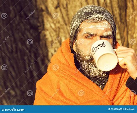 Frozen Man Bearded Hipster With Beard And Moustache Covered With White Frost Wrapped In Orange