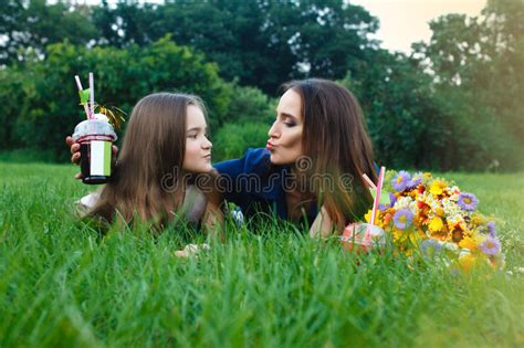 Mom And Daughter Are Laying In A Meadow And Drinking Juice Stock Image Image Of Daisy Fresh