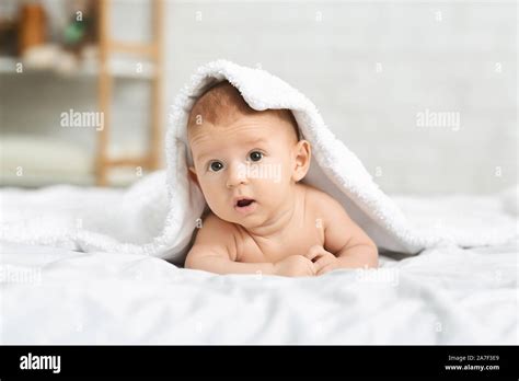 Cute Newborn Boy Peeking Out Under Soft White Blanket Stock Photo Alamy