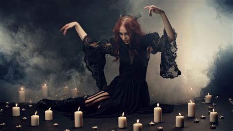 Red Haired Witch Sitting On Floor In Smoke Making Energetic Hand