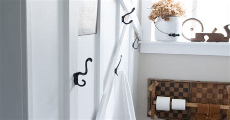 I have a small bathroom and what i did i bought a metal wine rack and hung it above the toilet, i fold my towels length wise in thirds and then roll the towel and place it in the cubby, then i found 2 hooks. Small Bathroom's Big Towel Wall | Hometalk