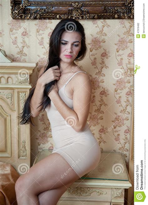 Young Beautiful Woman In White Short Tight Dress Posing