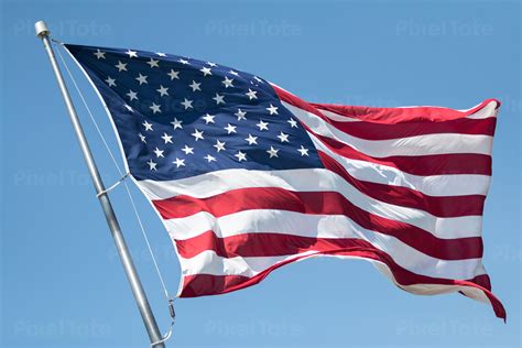American Flag Flying In The Wind Stock Photo Pixeltote