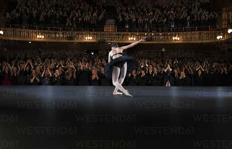 Ballerina Bowing On Stage In Theater Stock Photo