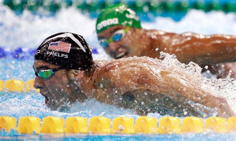 incredible midrace photos show chad le clos watched michael phelps clinching the gold for the win