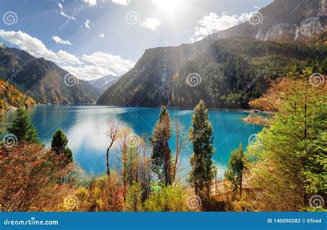 Scenic View Of The Long Lake With Azure Water Among Fall Woods Stock