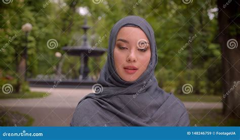 Portrait Of Muslim Woman In Hijab Watching Seriously Into Camera Standing In Front Of The