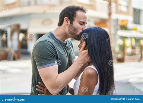 Man And Woman Interracial Couple Hugging Each Other And Kissing At