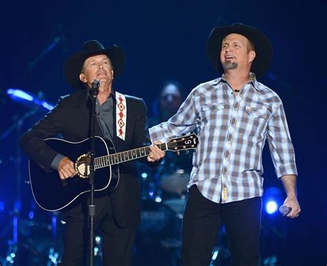 garth brooks and george strait perform together at the acm awards for the first time george
