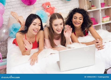 Three Girls Lying On Bed Speaking On Laptop They Are Celebrating Women