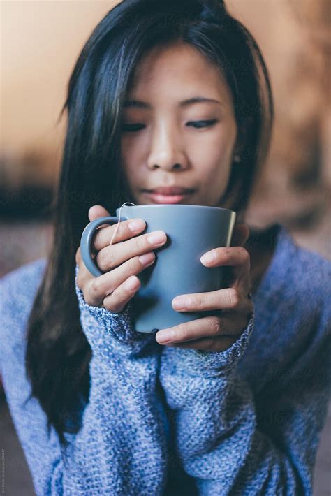 Woman Holding A Cup Of Tea Between Her Hands By Eva Plevier Hand