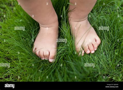 Small Baby Feet On The Green Grass Stock Photo Alamy