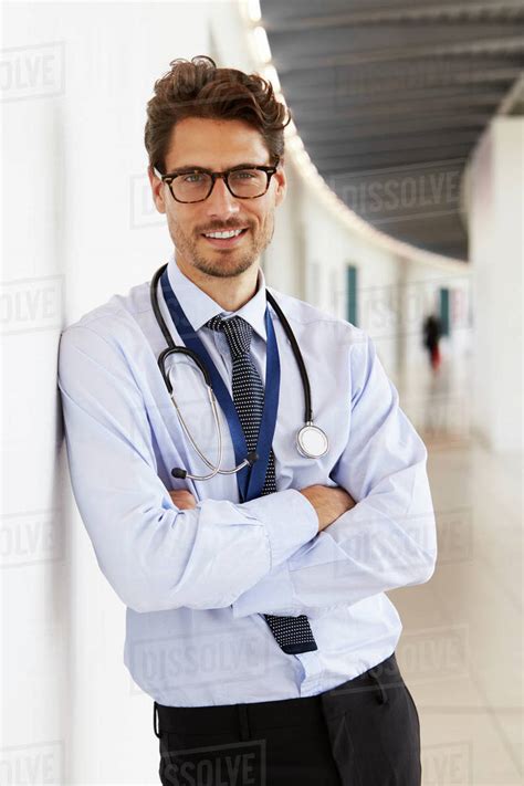 Portrait Of Young Male Doctor With Stethoscope Smiling Stock Photo