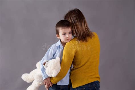 Sad Little Children Boys Hugging Their Mother At Home Isolated Image