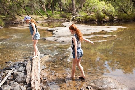 Image Of Two Girls Playing In The River Austockphoto