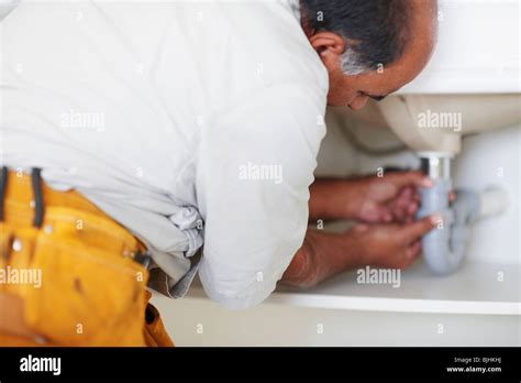 Plumber Fixing Sink Stock Photo Alamy