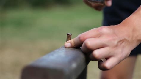 Premium Stock Video Blacksmith Hammering A Bullet On Anvil