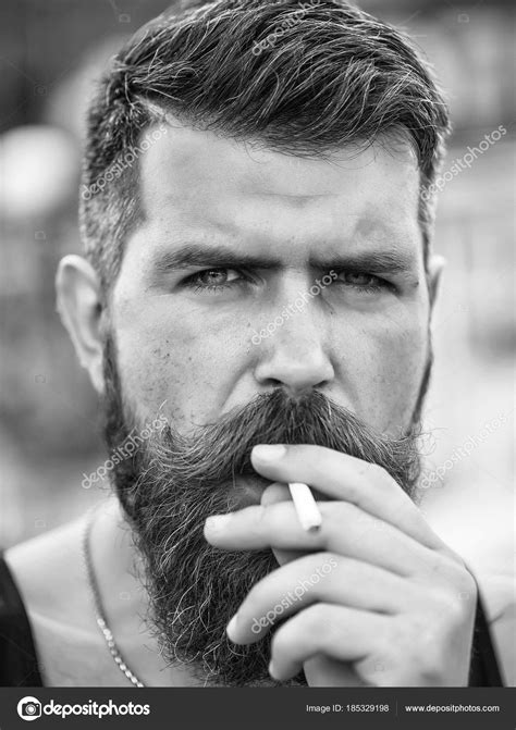 Frown Bearded Man Smoking Cigarette Stock Photo By ©