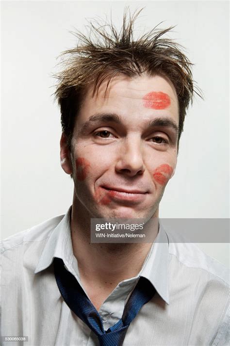 Portrait Of A Businessmans Face Covered With Lipstick Kisses High Res