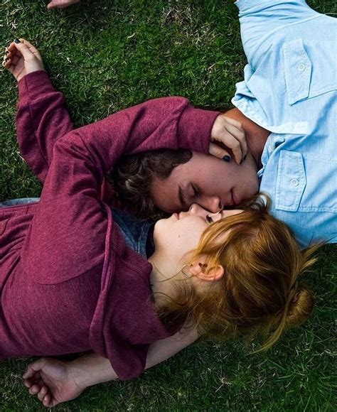 Couple Laying Down In Grass Holding Eachother Couples Doing Cute
