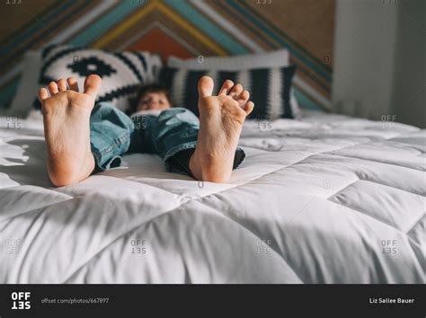 Barefoot Boy Lying On A Bed Stock Photo Offset