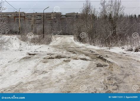 Bad Road With Deep Holes Water Ice And Snow In Russian City In Winter