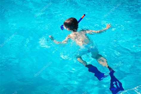 A Little Boy Diving Under Water Surface In A Swimming Pool — Stock