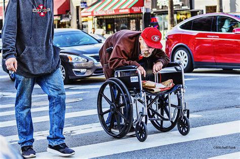 Man Leaning On Wheelchair Crossing The Street In The Tenderloin