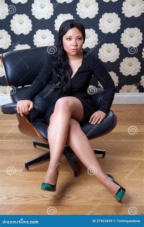 Confident Woman Sitting On A Leather Chair Stock Image 27423439